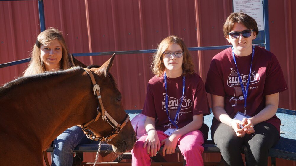 Miranda Breitag and other Special Olympics athletes with a horse.