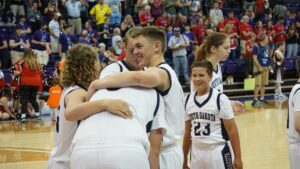 Members of the Unified Team hugging on the basketball court.