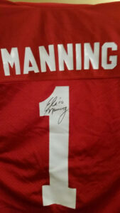 The signed Manning jersey.